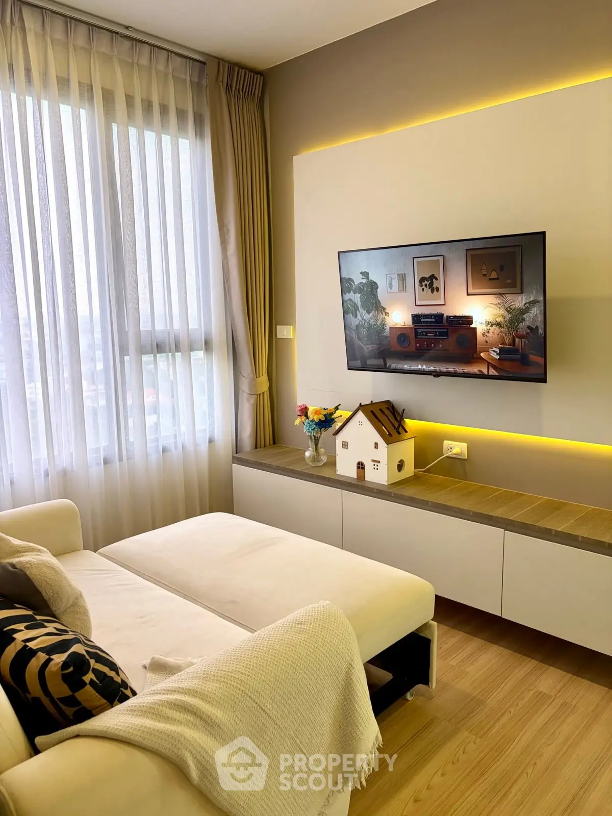 Modern living room with stylish decor and wall-mounted TV