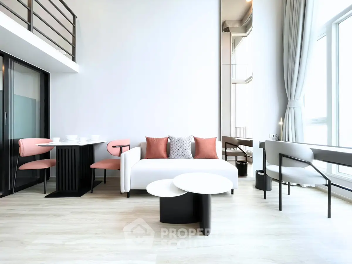 Modern living room with high ceilings, stylish furniture, and large windows offering abundant natural light.