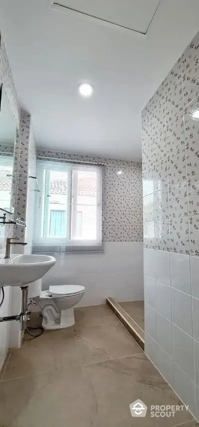 Bright bathroom with modern fixtures and large window for natural light