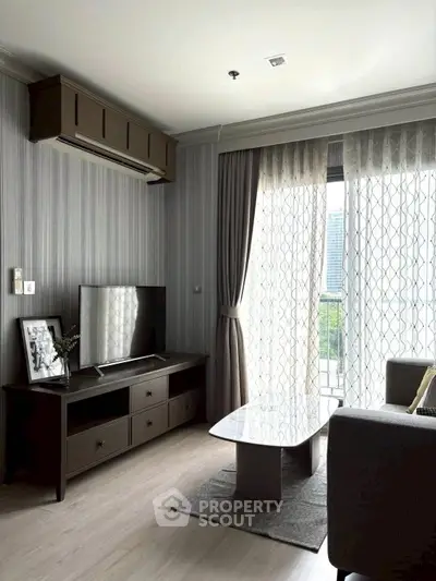 Modern living room with stylish decor, large window, and sleek furniture in a contemporary apartment.