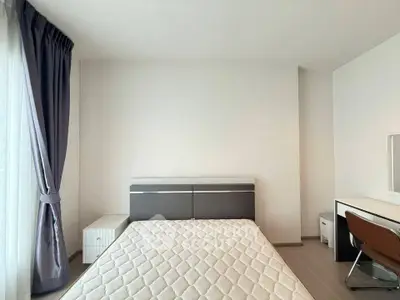 Modern minimalist bedroom with natural light and sleek furniture