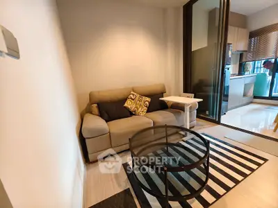 Modern living room with cozy sofa and glass coffee table in stylish apartment.