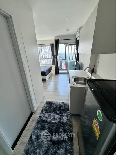 Modern studio apartment with open kitchen and city view balcony