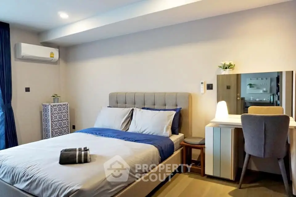 Modern bedroom with stylish decor and cozy ambiance, featuring a comfortable bed and elegant furniture.
