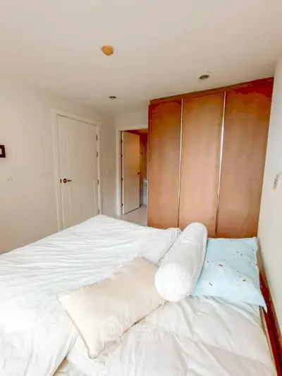 Cozy bedroom with modern wardrobe and inviting bed setup
