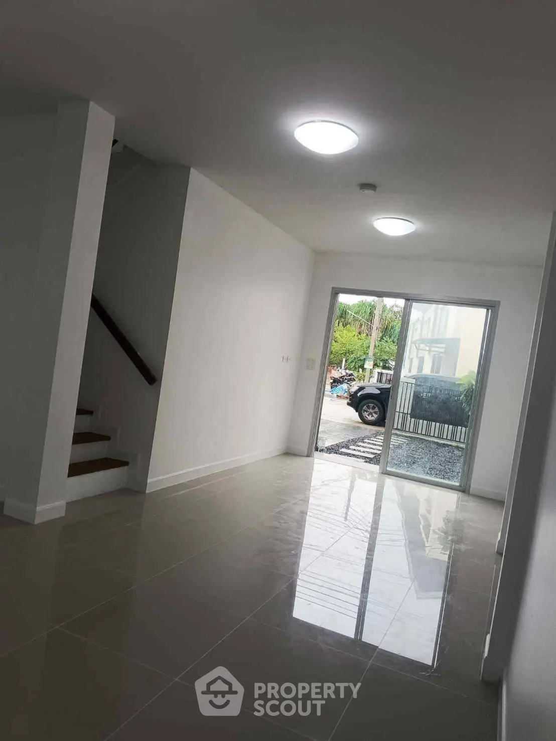 Spacious modern interior with sleek tile flooring and natural light