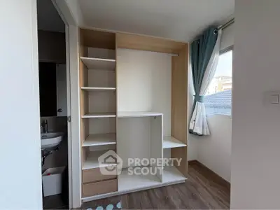 Modern bedroom with built-in closet and natural light