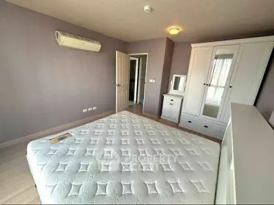 Spacious bedroom with modern air conditioning and elegant wardrobe in a cozy apartment.