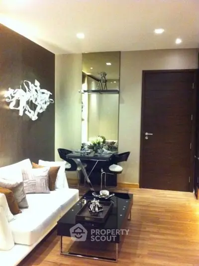 Modern living room with stylish decor and elegant dining area in a cozy apartment.