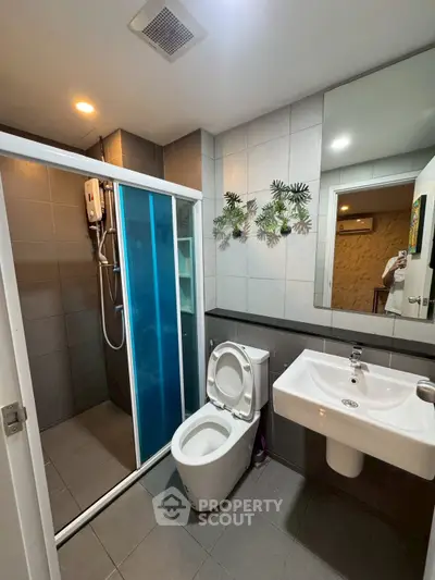 Modern bathroom with shower and sleek fixtures in contemporary apartment
