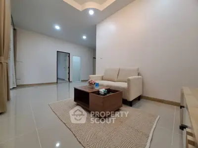 Spacious living room with modern sofa and coffee table, ideal for relaxation and entertaining.