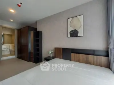 Modern bedroom with stylish decor and spacious layout in luxury apartment.