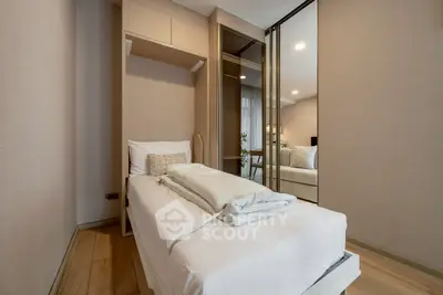 Modern bedroom with sleek design and mirrored closet doors