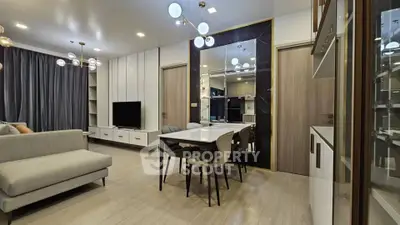 Modern living room with elegant dining area and stylish lighting fixtures