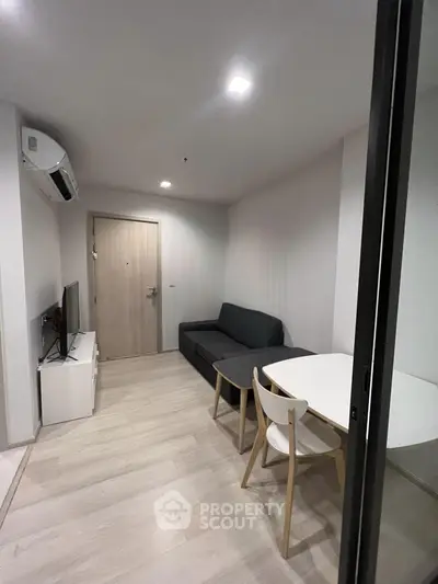 Modern living room with sleek furniture and minimalist design in a cozy apartment.
