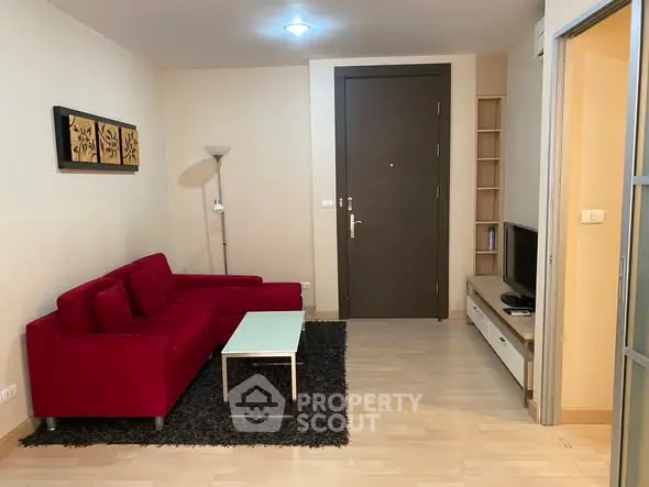 Modern living room with red sofa and sleek decor