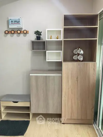 Modern interior with stylish wooden storage and decorative shelves in a cozy living space.