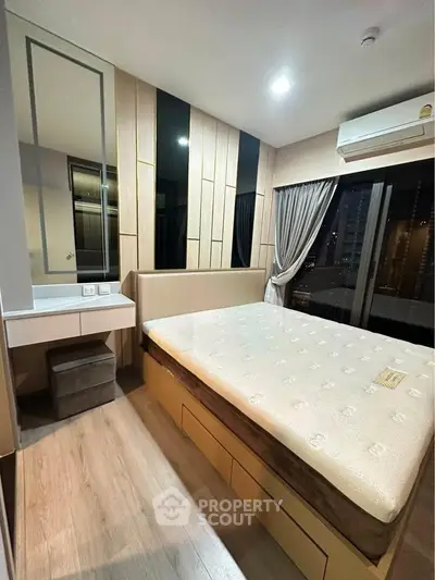 Modern bedroom with large window and stylish decor in a high-rise apartment.