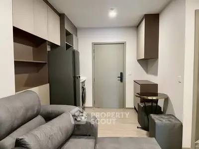 Modern living room with sleek furniture and appliances in a compact layout.