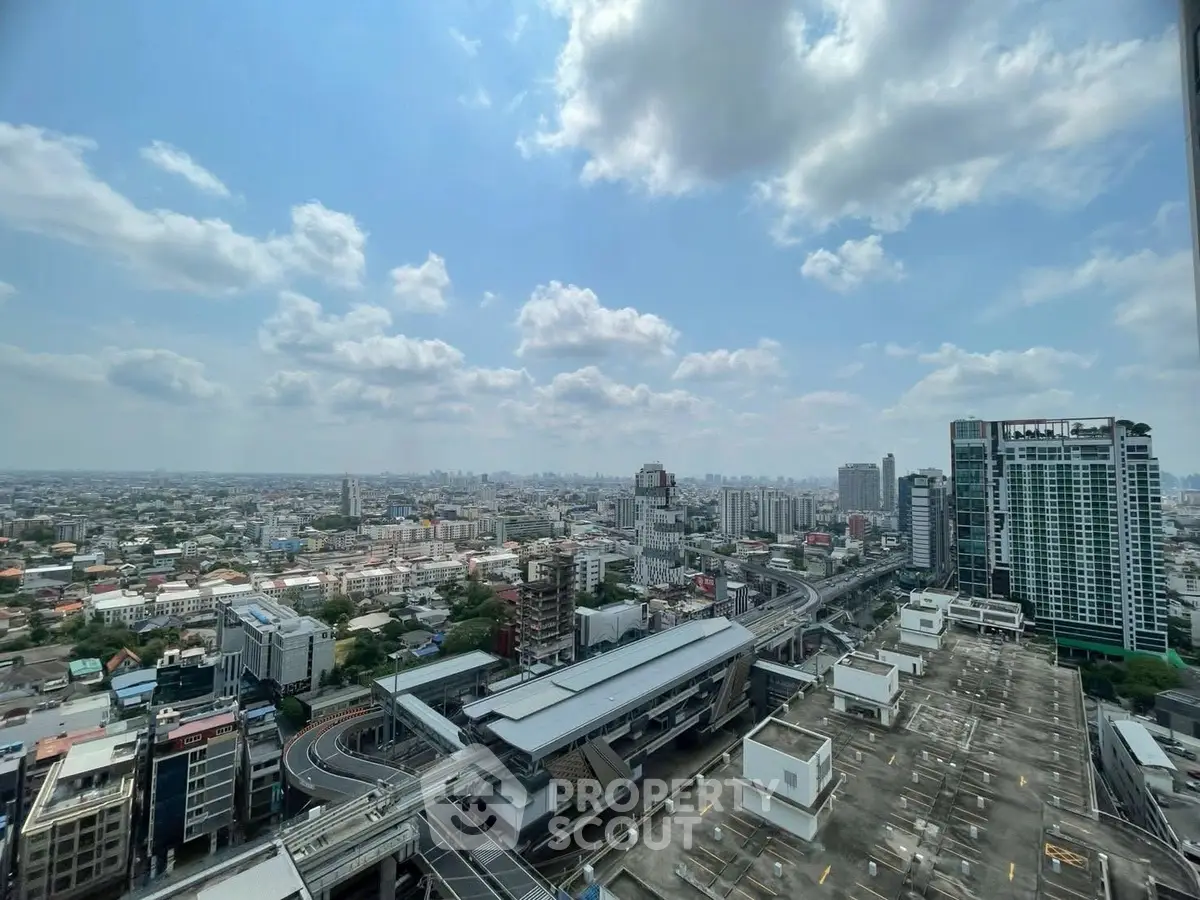 Stunning cityscape view from high-rise building showcasing urban skyline and transportation hub.