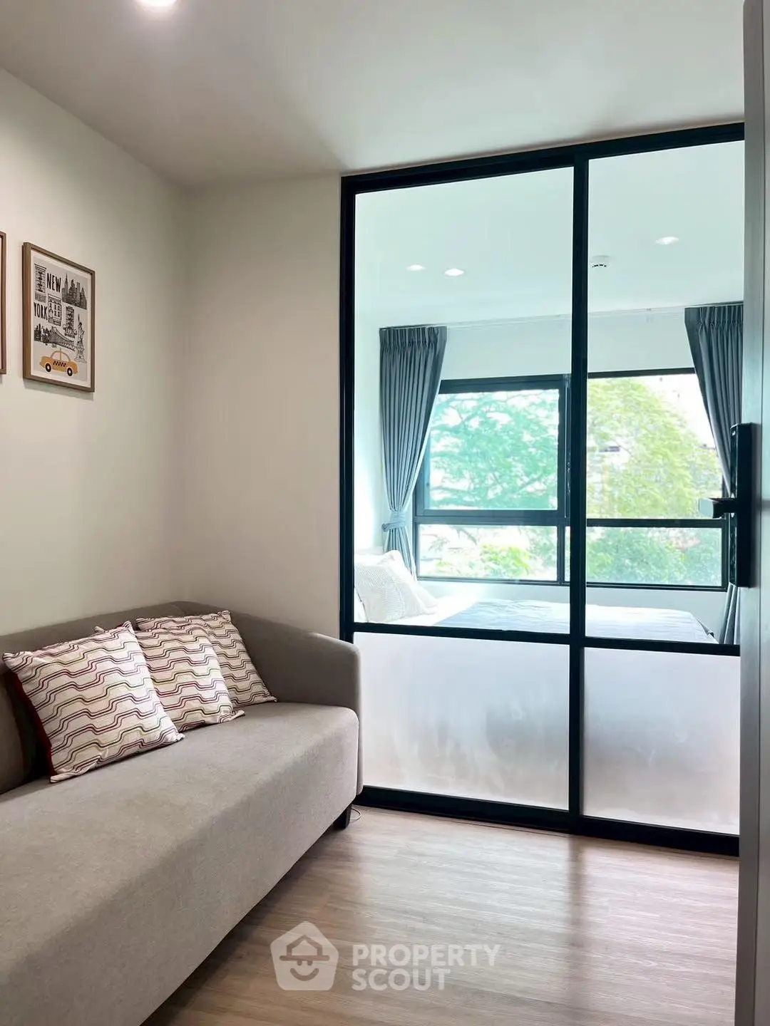 Modern apartment interior with cozy living area and bright bedroom view.