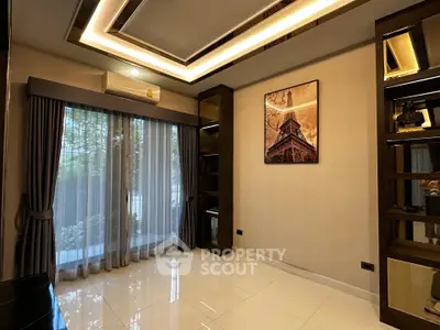 Elegant living room with modern ceiling design and large window view