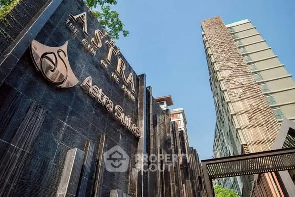 Luxurious Astra Suites building exterior with modern architectural design and prominent signage.