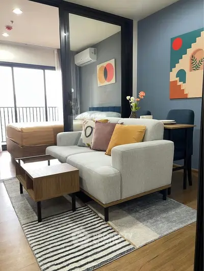 Modern living room with stylish decor and natural light in a cozy apartment.