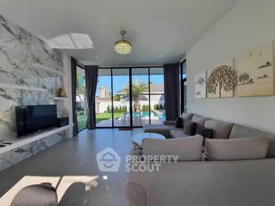 Luxurious living room with marble accents and garden view