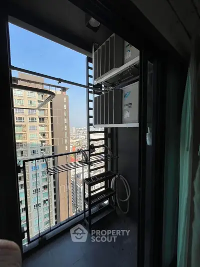 High-rise balcony with city view and laundry drying rack, perfect for urban living.
