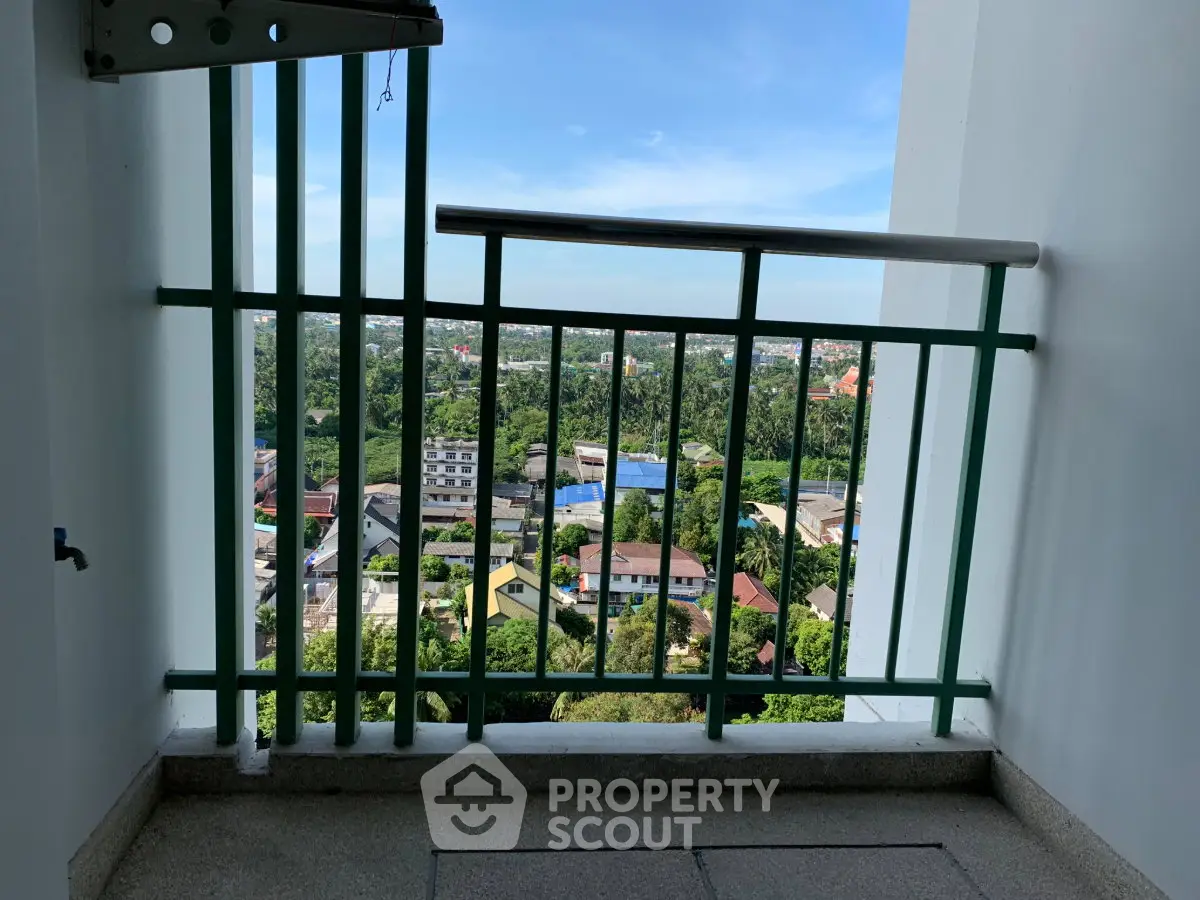 Stunning balcony view overlooking lush greenery and cityscape, perfect for relaxation and enjoying the outdoors.