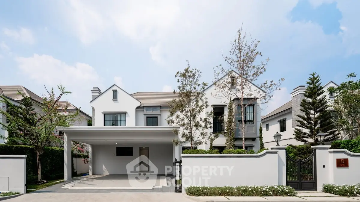 Elegant modern house exterior with spacious driveway and lush greenery, perfect for luxury living.