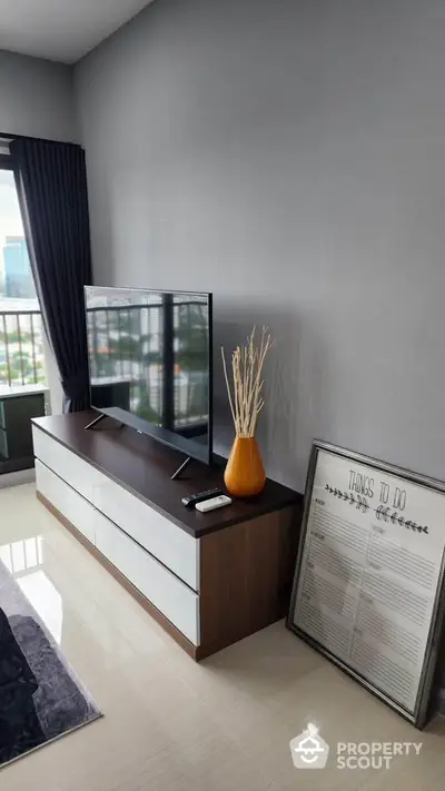 Modern living room with sleek TV stand and balcony view