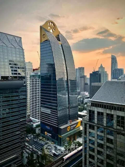 Stunning modern skyscraper with unique architecture in bustling cityscape at sunset.