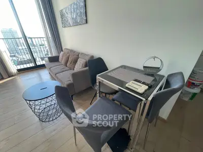 Modern living room with city view, stylish furniture, and natural light.