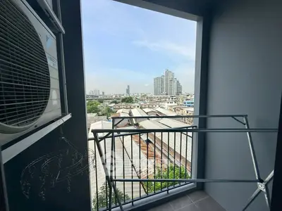 Urban balcony with cityscape view and air conditioning unit, perfect for modern living.