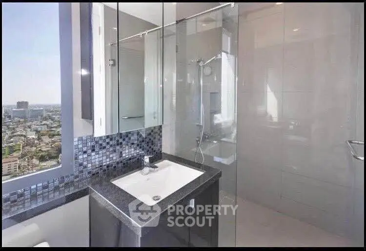 Modern bathroom with city view, featuring sleek glass shower and stylish vanity.