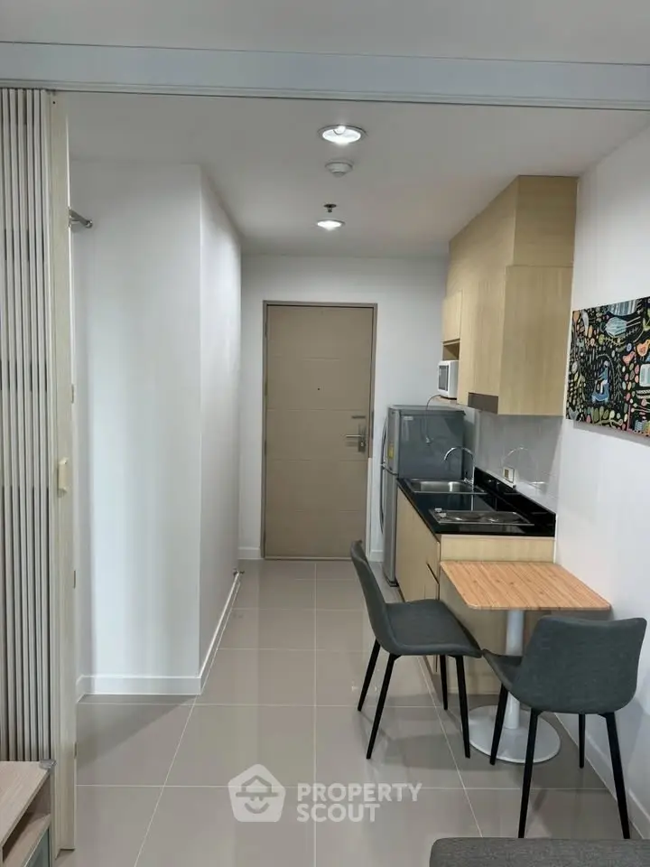 Modern compact kitchen with dining area in a stylish apartment