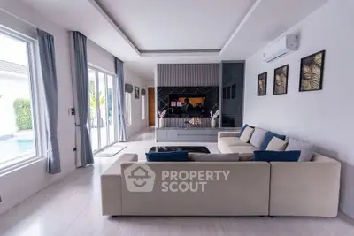 Spacious modern living room with pool view and elegant decor
