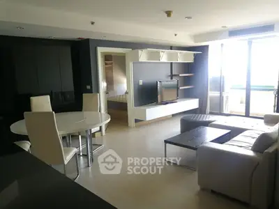 Spacious modern living room with sleek furniture and large windows offering natural light.