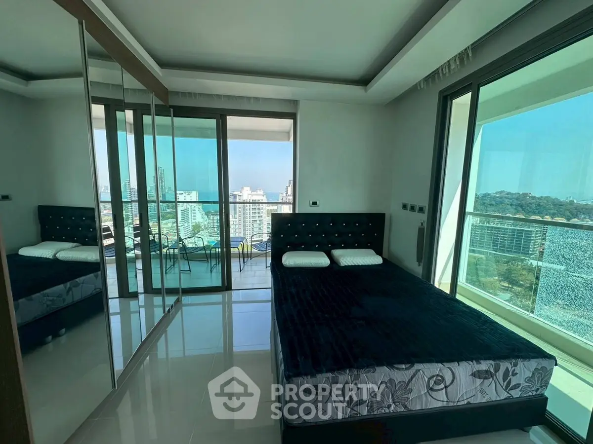 Luxurious bedroom with stunning city view and spacious balcony access.