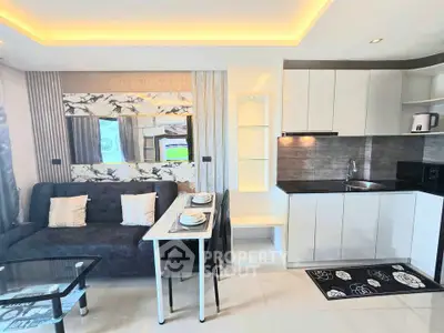 Modern open-plan living room and kitchen with sleek design and stylish decor.