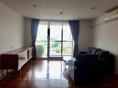 Spacious living room with modern furniture and large balcony view.
