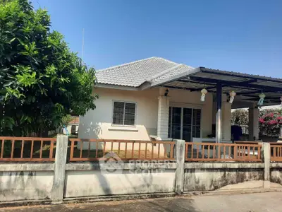 Charming single-story house with a spacious yard and covered patio, perfect for family living.