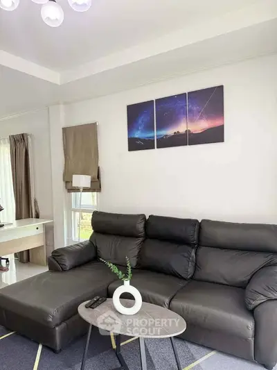 Modern living room with sleek black leather sofa and stylish decor