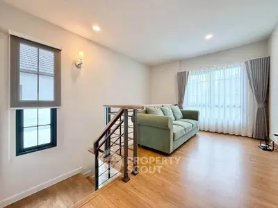 Spacious living room with modern decor and large windows for natural light.