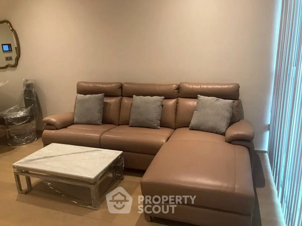 Modern living room with leather sectional sofa and marble coffee table