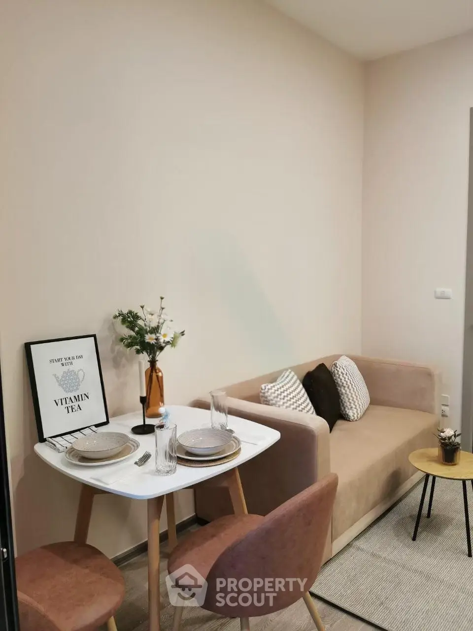 Cozy living room with modern decor and dining area in a stylish apartment.