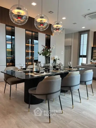 Luxurious dining room with elegant decor and modern lighting in a stylish apartment.
