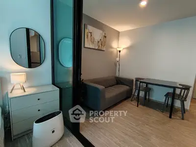 Modern living room with sleek furniture and ambient lighting in a cozy apartment.